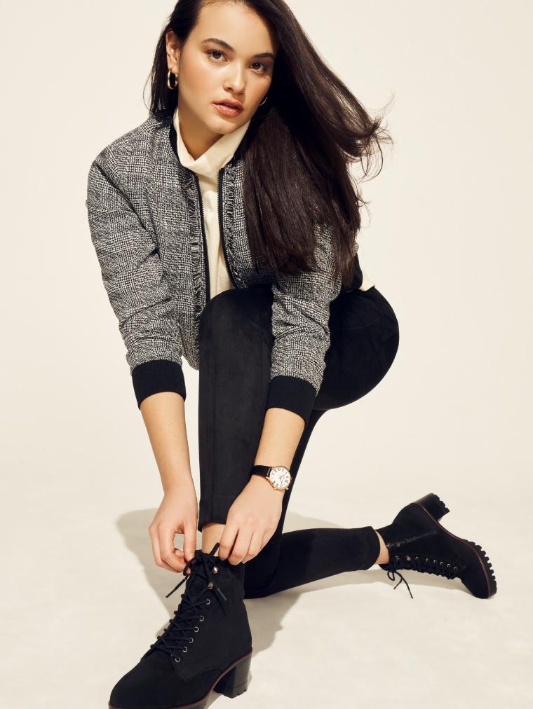 Anne Klein Model tying lace-up boots